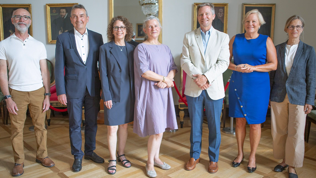 Seven people posing for a group photo