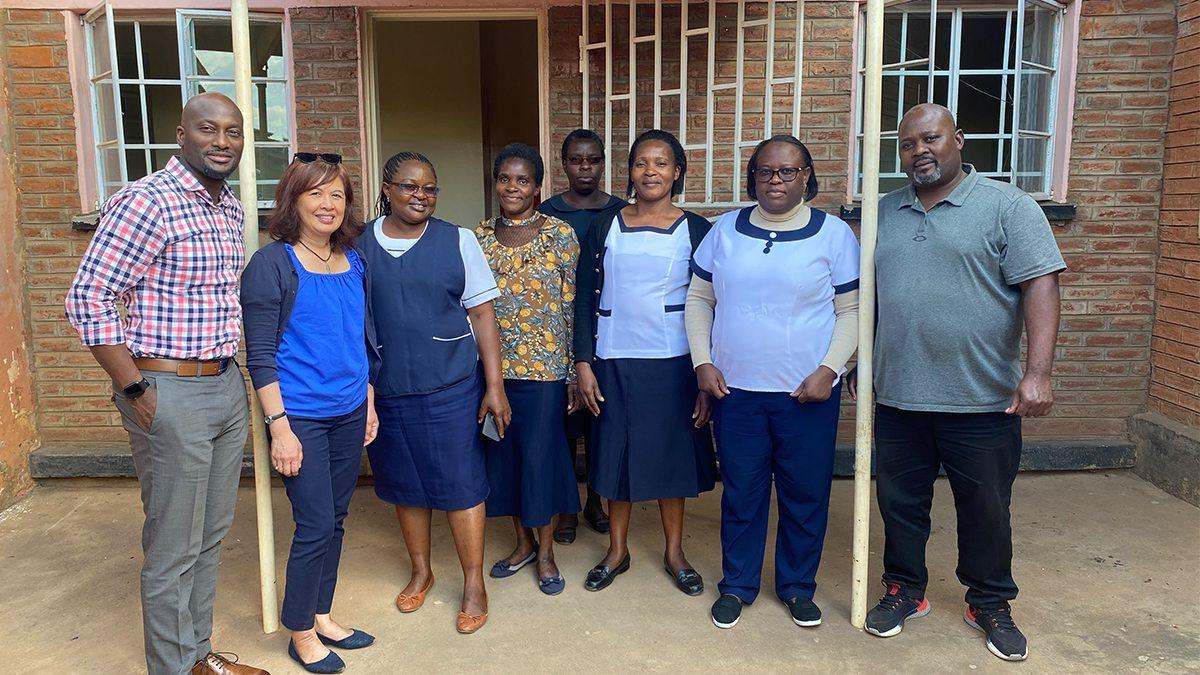 Arlene Sena standing next to individuals who work at an STI clinic.